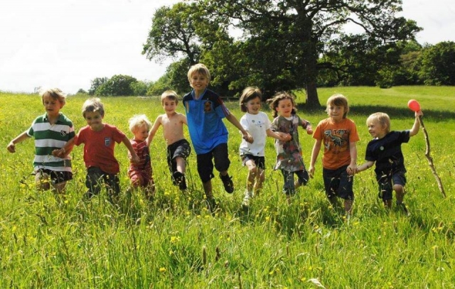 children running through long grass